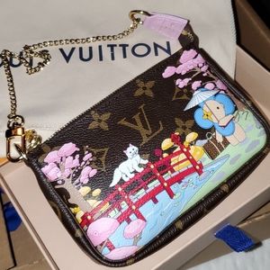Authentic Louis Vuitton Vivienne mini pochette